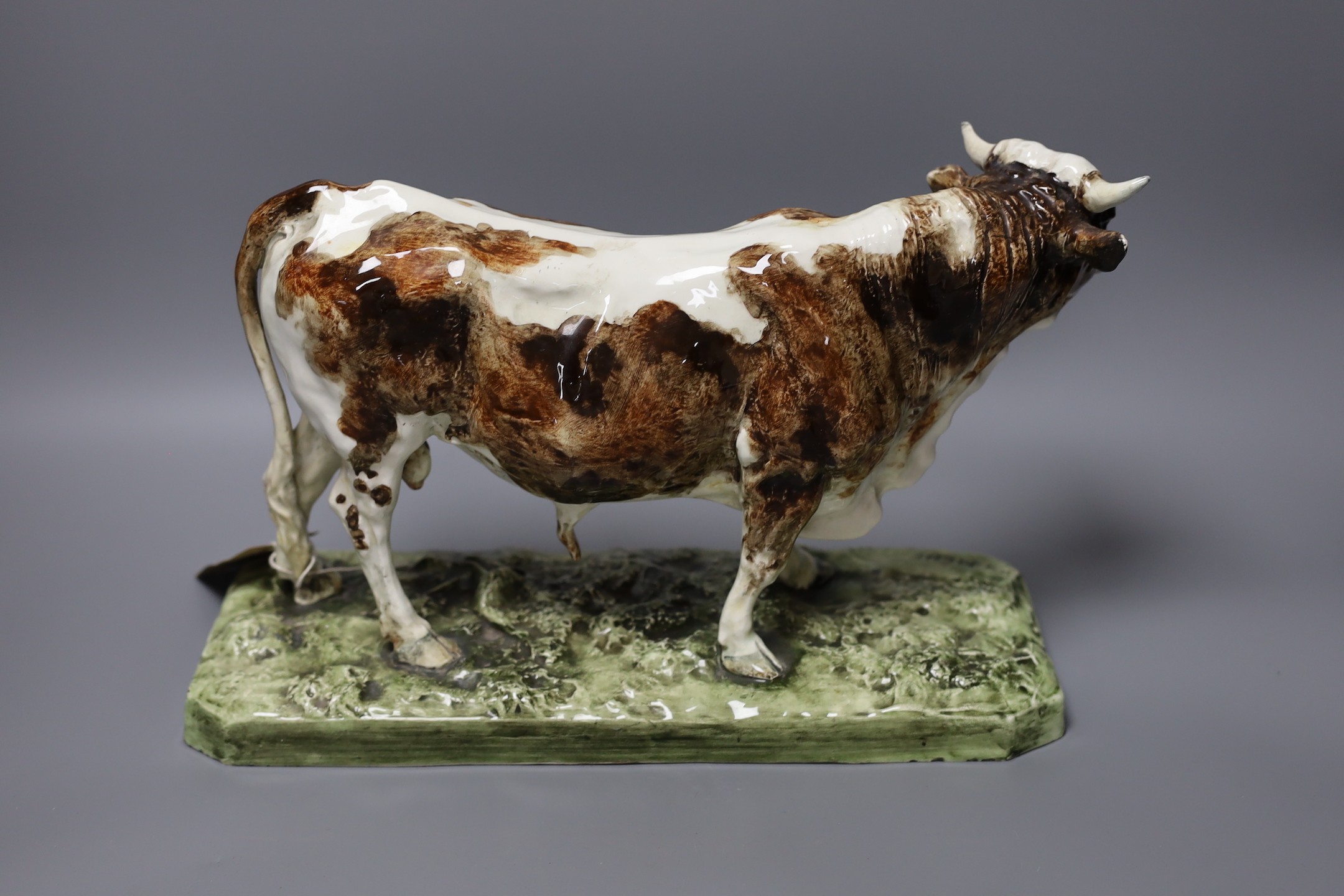 After Pierre Jules Mene (1810-1879) - a faience model of a bull, 'Taureau Normand', impressed signature, 35cm wide